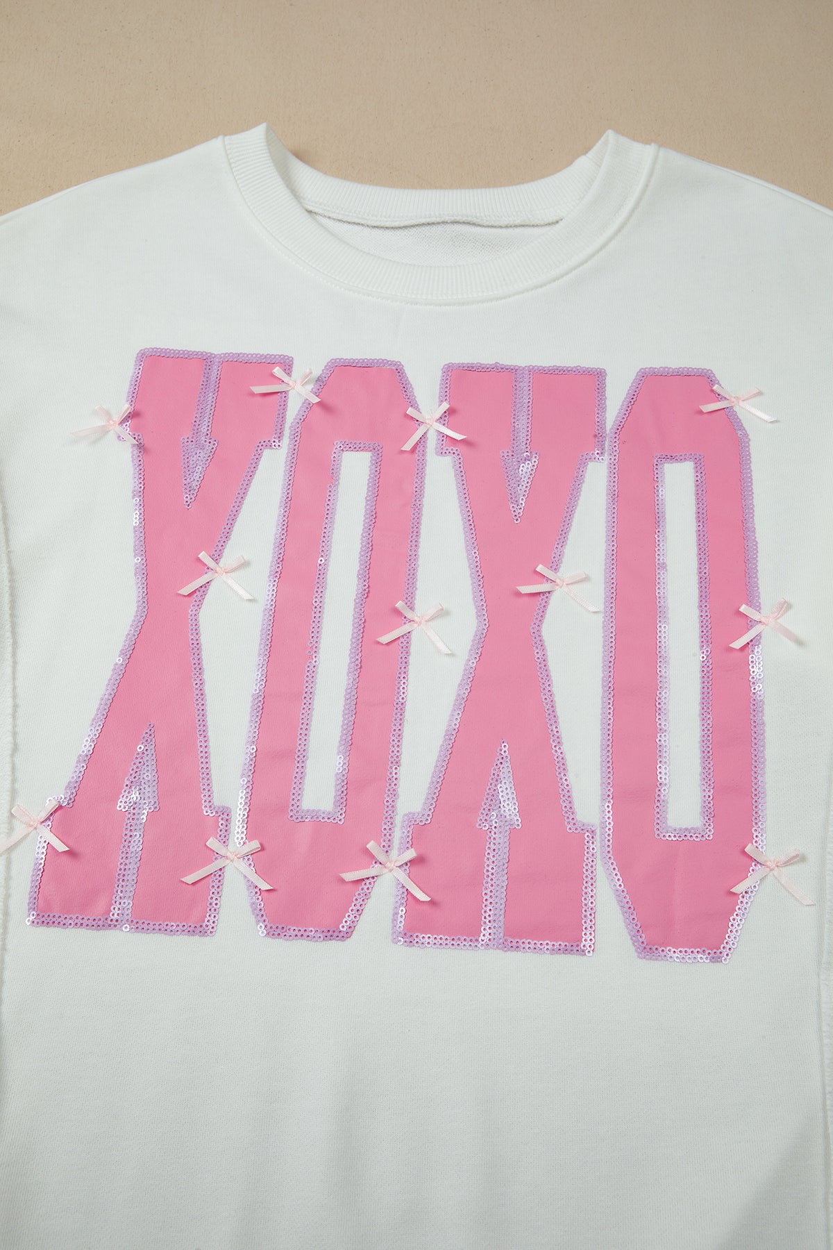KaleaBoutique Stylish Bow Sequin XOXO Letter Graphic Exposed Seam Baggy Sweatshirt - KaleaBoutique.com