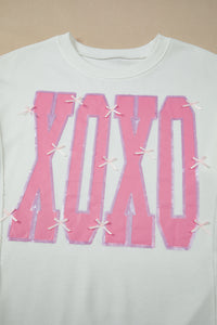 KaleaBoutique Stylish Bow Sequin XOXO Letter Graphic Exposed Seam Baggy Sweatshirt - KaleaBoutique.com