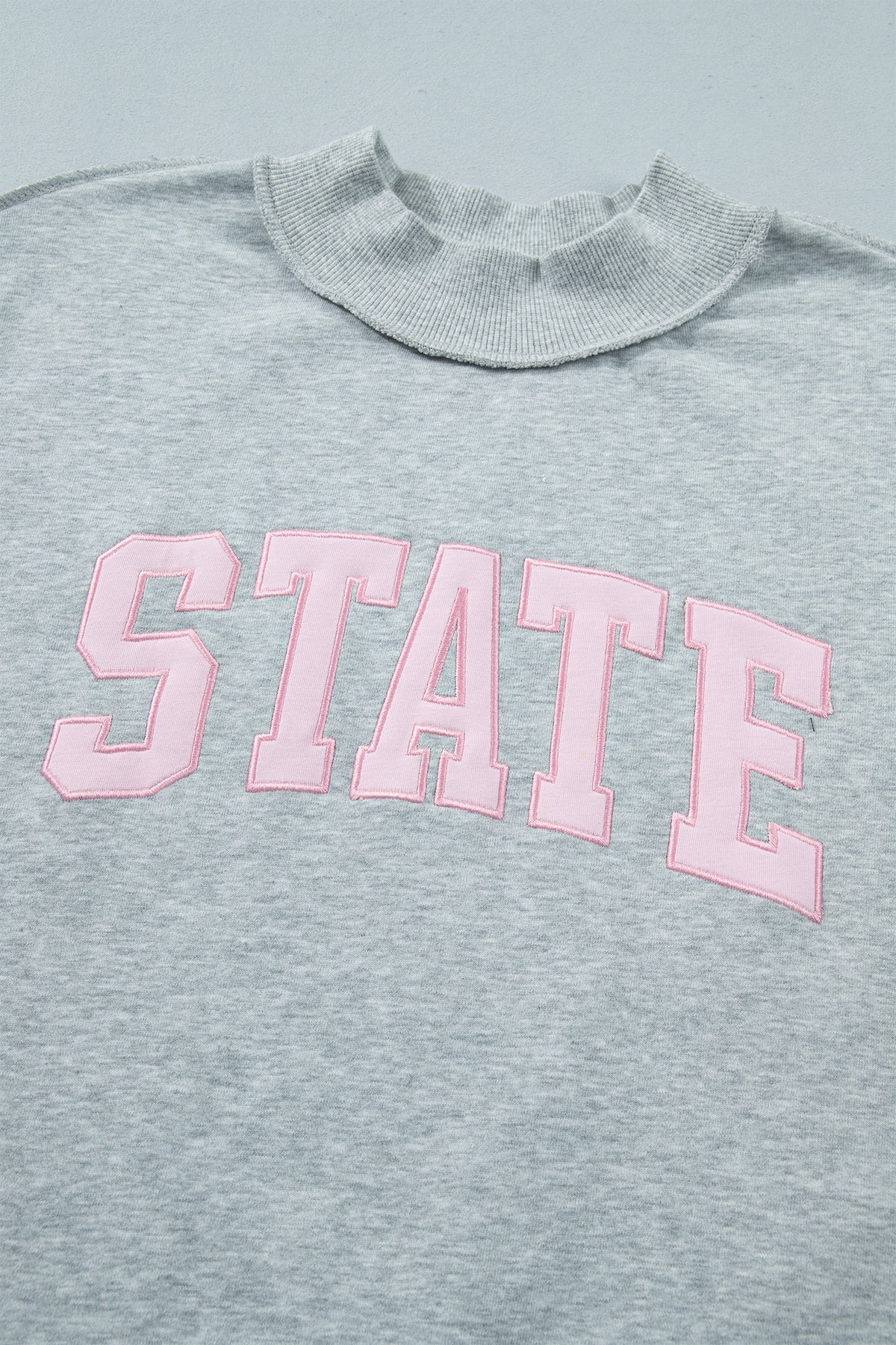 KaleaBoutique Comfortable Exposed Seam Mock Neck STATE Letter Graphic Loose Sweatshirt - KaleaBoutique.com
