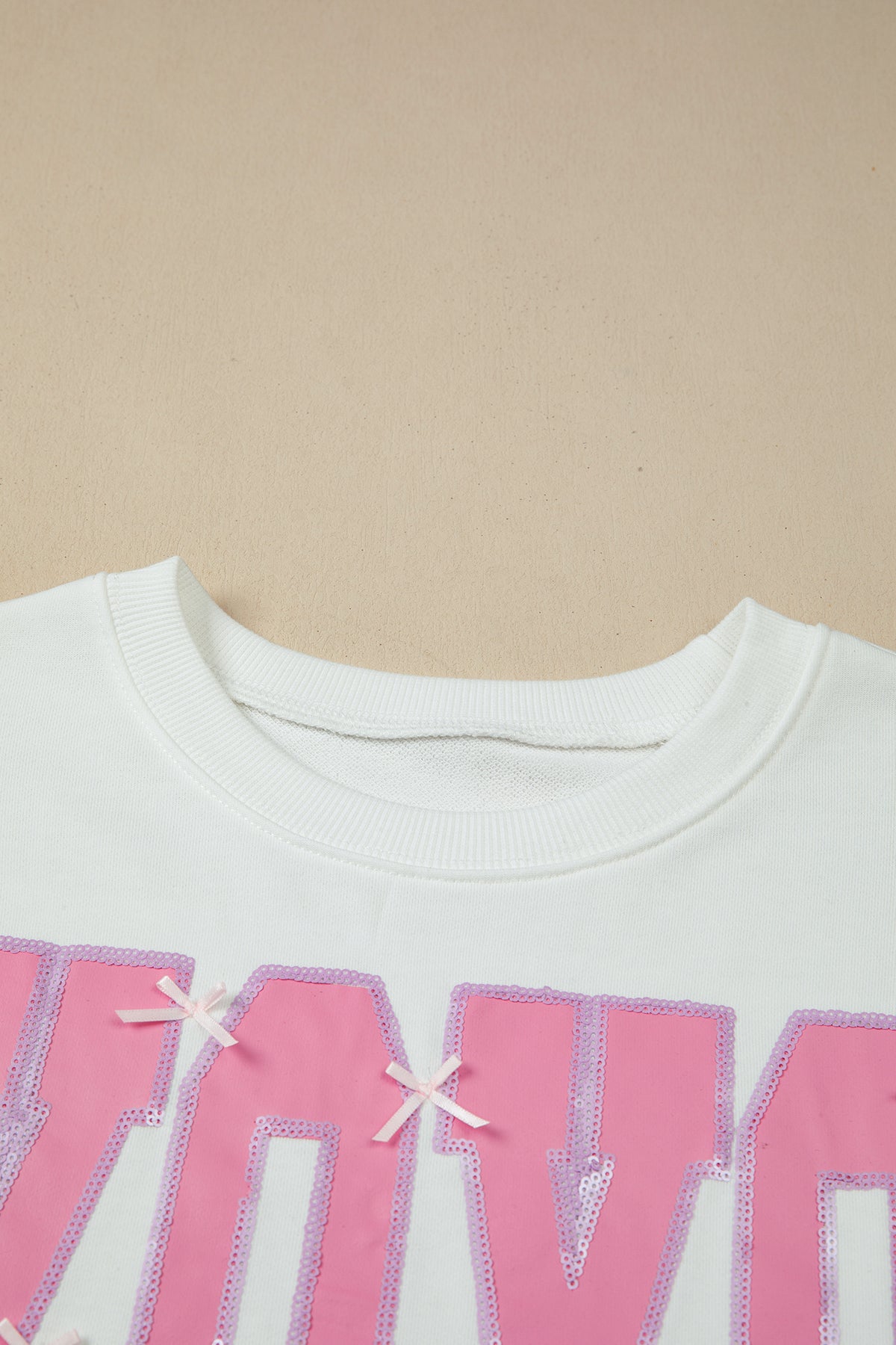 KaleaBoutique Stylish Bow Sequin XOXO Letter Graphic Exposed Seam Baggy Sweatshirt - KaleaBoutique.com